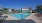 community swimming pool with lounge seating surrounding 