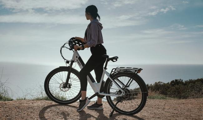A beautiful community at the heart of all your passions a woman standing next to a bicycle